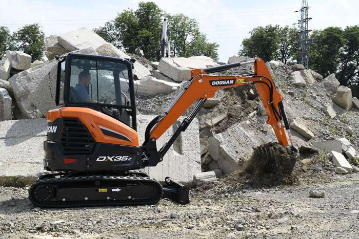 the new look Develon DX35z mini excavator on site moving rubble