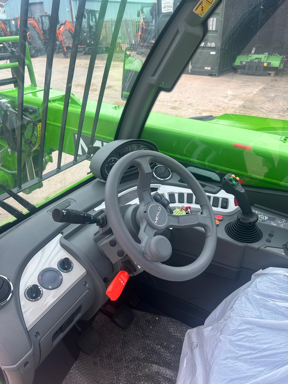 Merlo P27.6 cab interior showing the steering wheel and controls